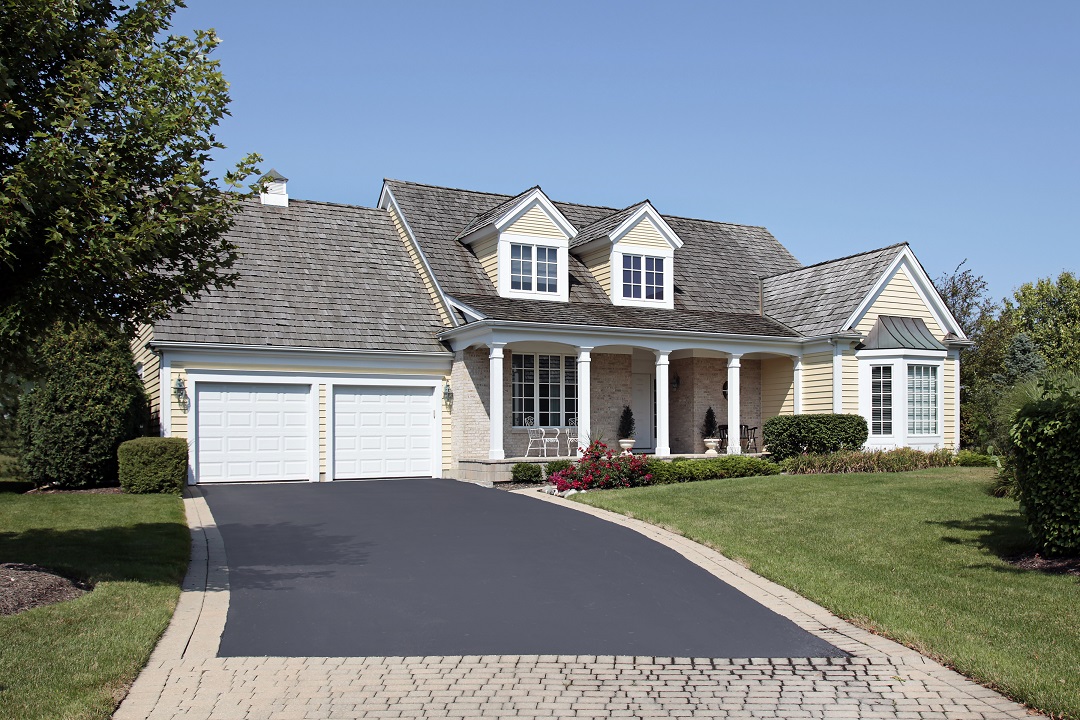 Home with front porch and partial brick driveway