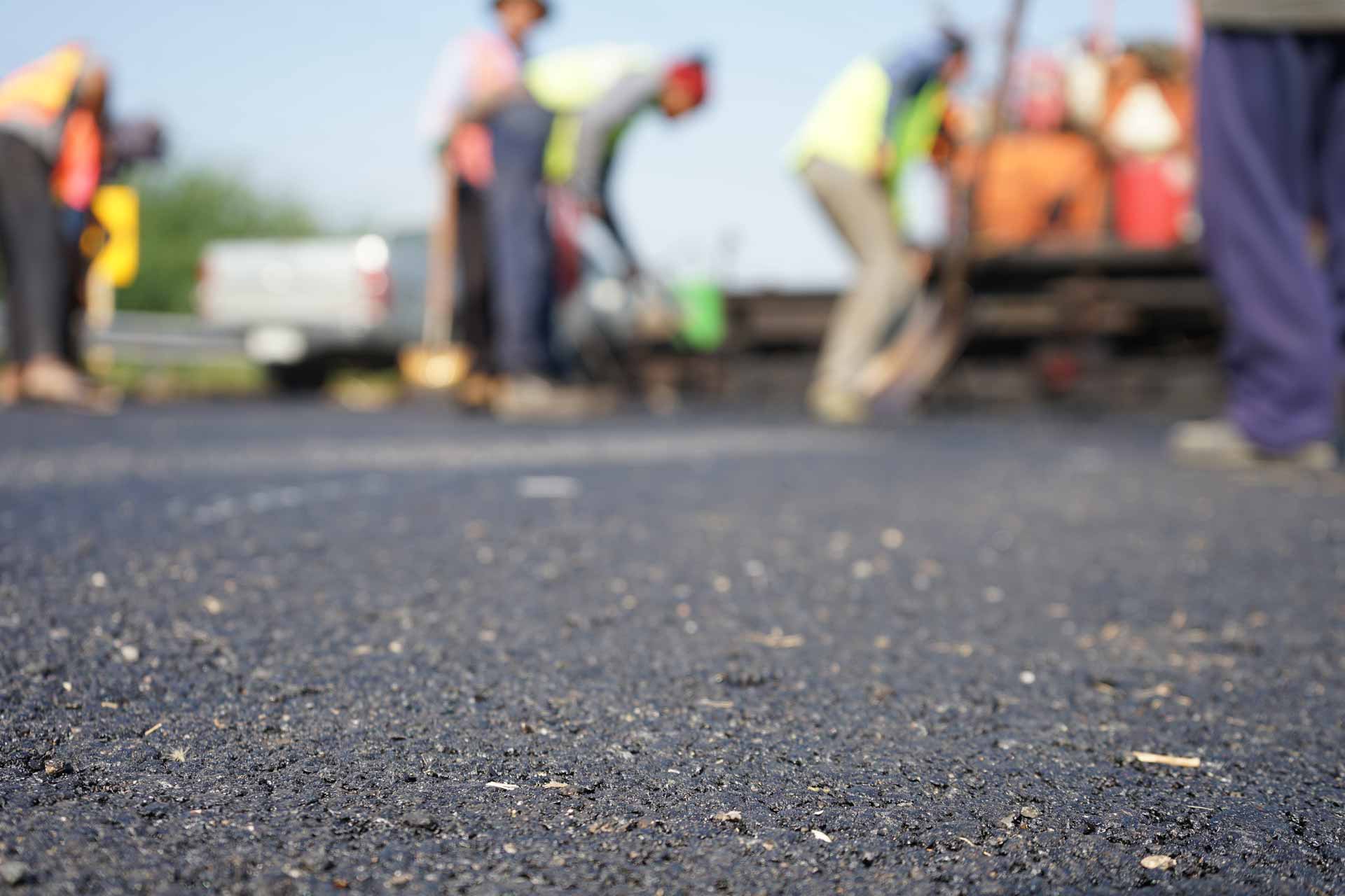 Construction workers on the asphalt road