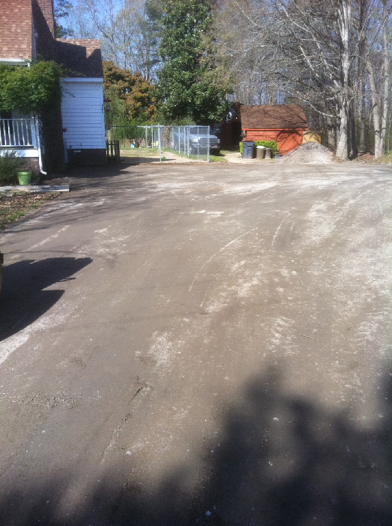 An old, cracked asphalt driveway
